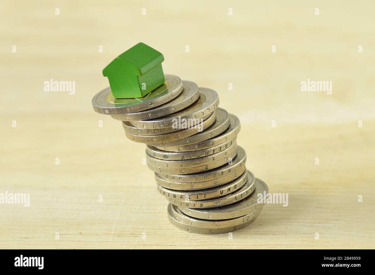 House on stack of coins - Concept of real estate investing and housing market Stock Photo