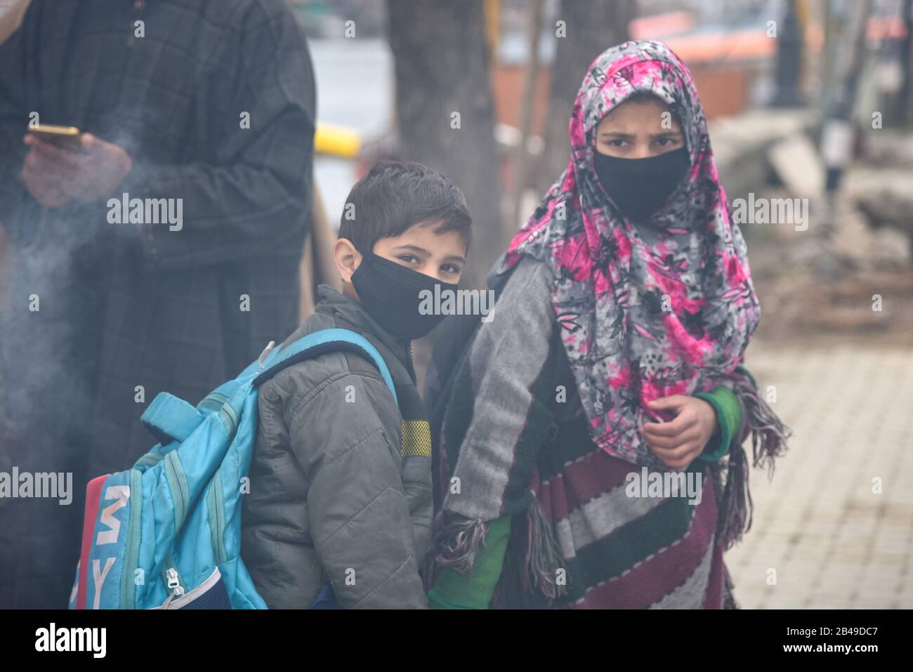 Kashmiri students looks on as they wear protective face masks amid  Coronavirus fears in Srinagar.Fear has gripped among people in Kashmir  valley after at least five persons with a recent history of