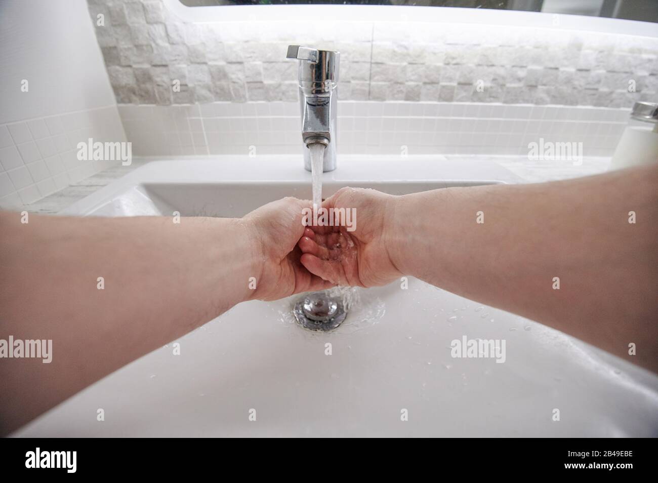 Cleaning hands before eating in bathroom close up view Stock Photo