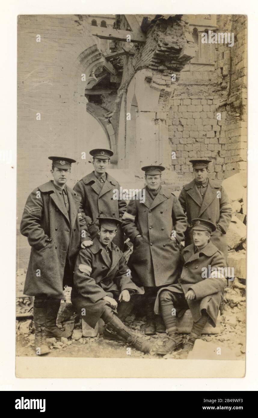 WW1 era postcard of post office workers from Brighton, 28th Division Signal Company, standing next to the ruins of Ypres Cathedral, dated on reverse April 1915, 2nd battle Ypres, Western Flanders, Belgium Stock Photo