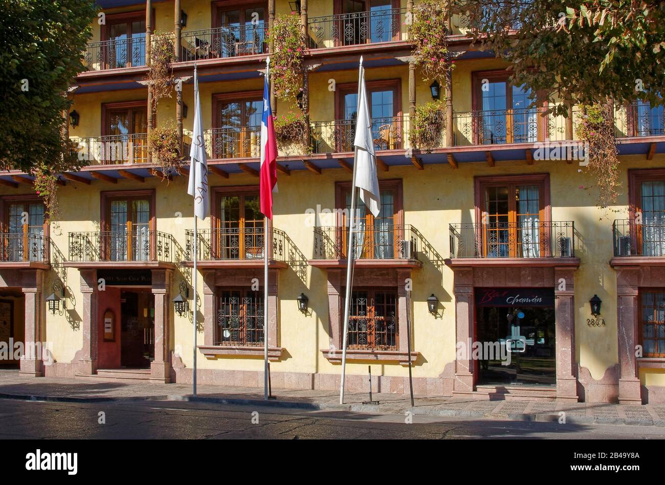 Hotel Santa Cruz Plaza; front facade, balconies, French doors, flowers, hacienda style, Santa Cruz; Chile; South America; summer Stock Photo