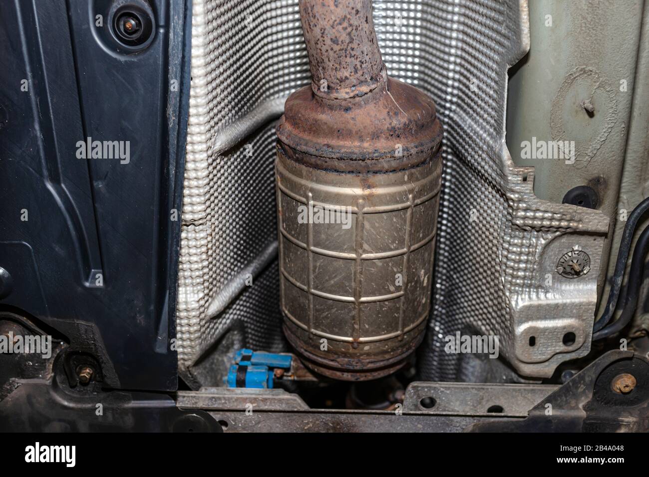 A diesel particulate filter in the exhaust system in a car on a lift in
