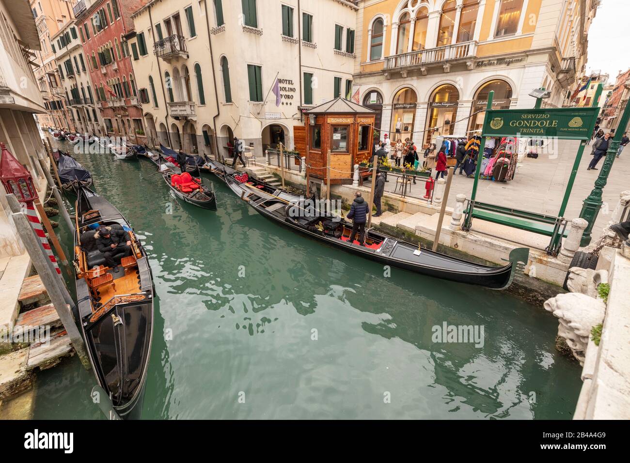 Venice, February 25th - March 3rd. 2020: Gondalas moored along a canal  as Coronavirus epidemic has had the effect of detering tourists from visiting the island and has resulted in Gondoliers losing custom. Stock Photo