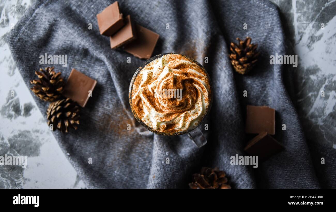 iced coffee with cream on rustic table, Coffee drink in a transparent mug with chocolate Stock Photo