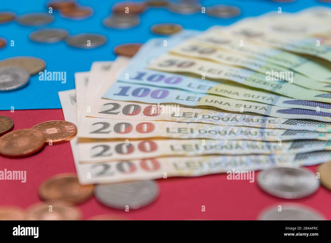 Romanian banknotes and coins on a blue and red background. Coloseup of RON, Romanian Currency. Romanian RON, Lei Banknotes issued by BNR, National Ban Stock Photo