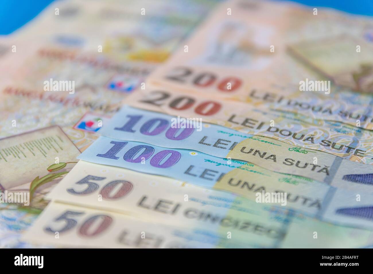 Romanian banknotes on a blue and red background. Coloseup of RON, Romanian Currency. Romanian RON, Lei Banknotes issued by BNR, National Bank of Roman Stock Photo