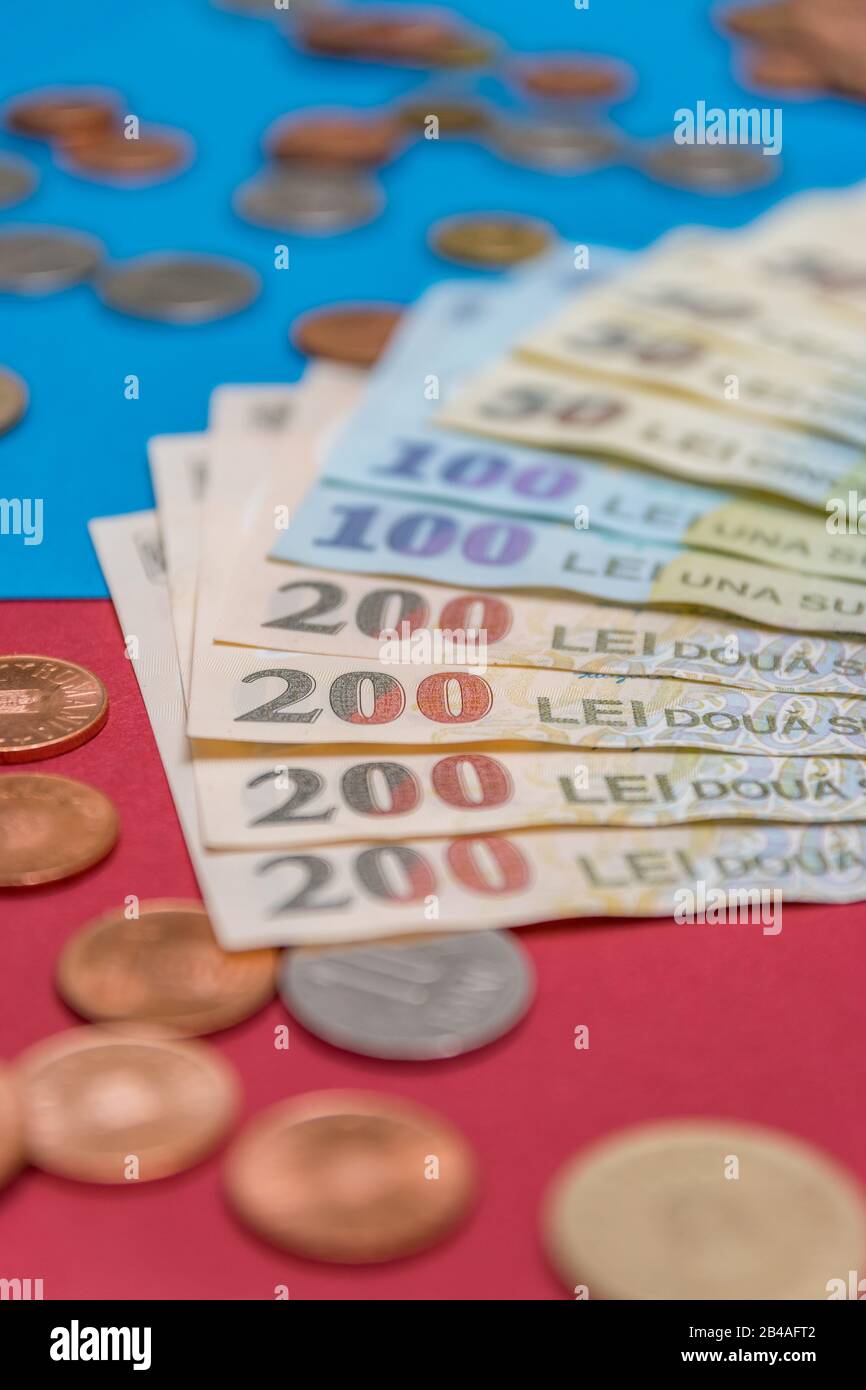 Romanian banknotes and coins on a blue and red background. Coloseup of RON, Romanian Currency. Romanian RON, Lei Banknotes issued by BNR, National Ban Stock Photo