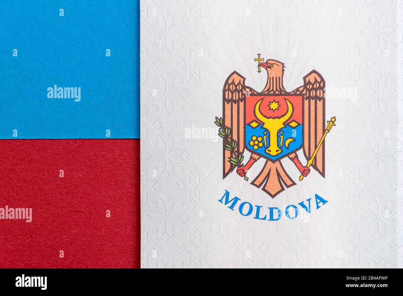 Republic of Moldova concept. The Moldovan passport on a blue and red background. Coloseup of the emblem/coat of arms of Moldova. Moldova Finance and e Stock Photo