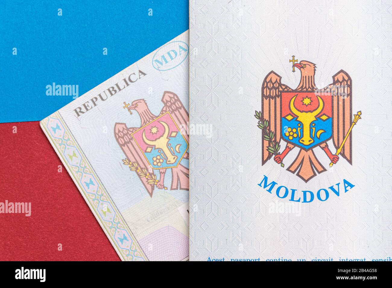 Republic of Moldova concept. The Moldovan passport on a blue and red background. Coloseup of the emblem/coat of arms of Moldova. Moldova Finance and e Stock Photo