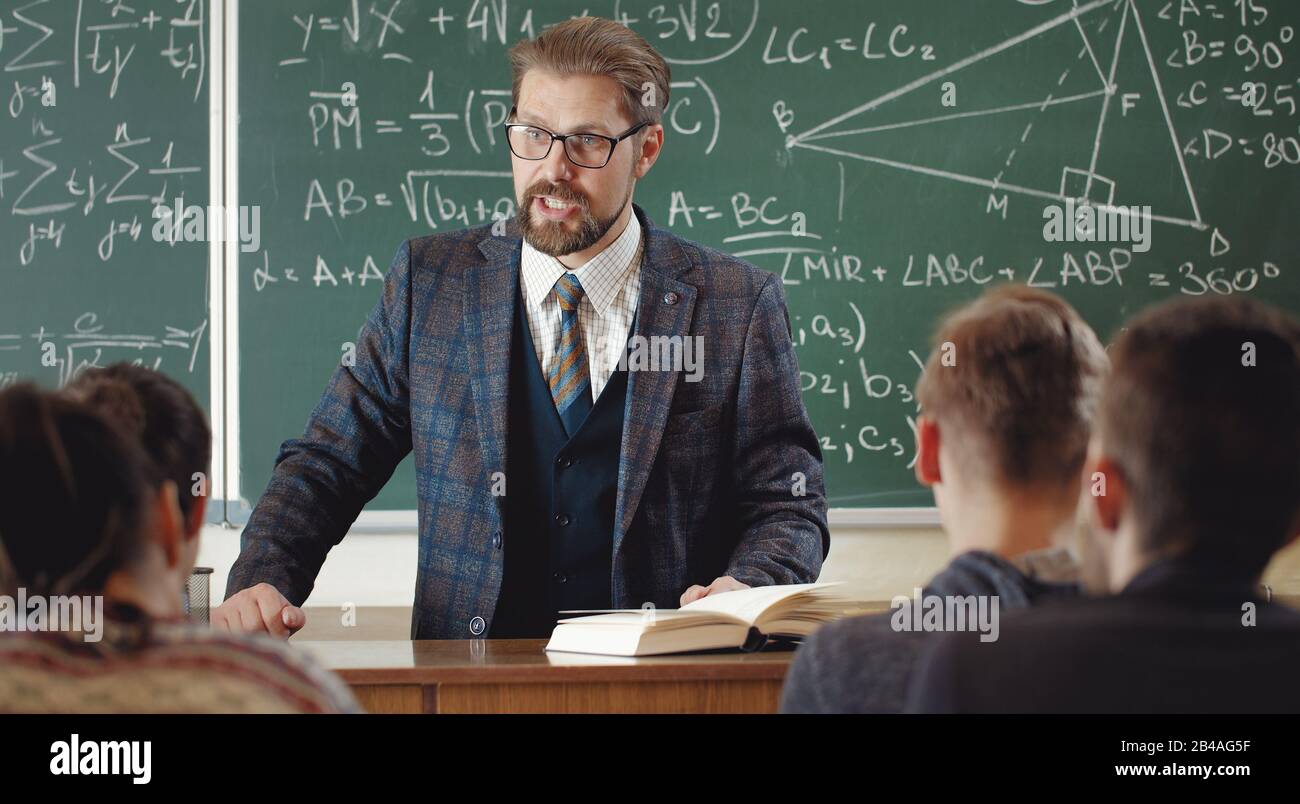 Professor with students in schoolroom Stock Photo