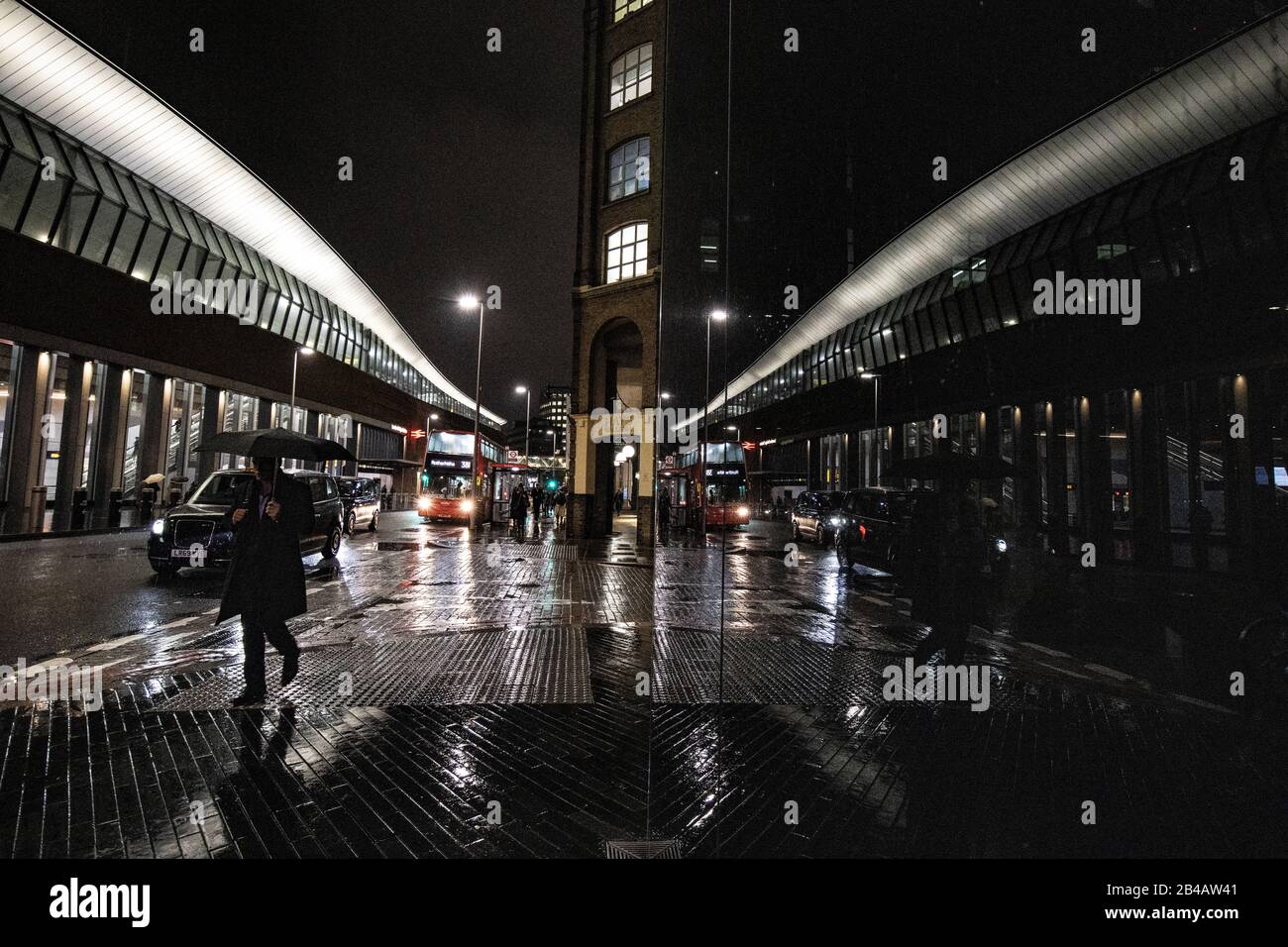 Tooley Street on a wet winter night, City of London, England, United Kingdom Stock Photo