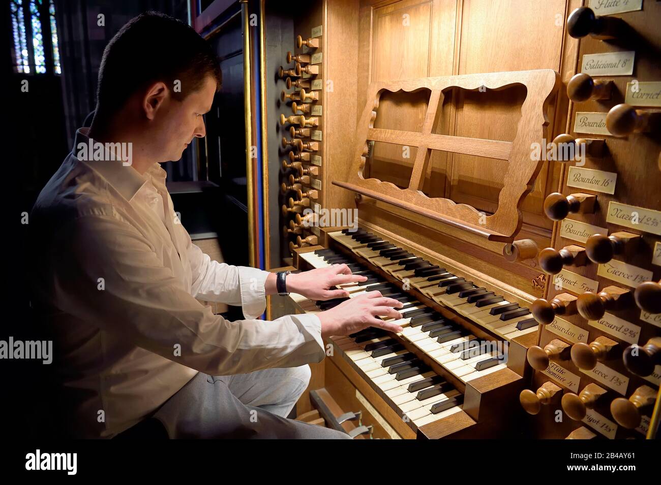 France, Bas Rhin, Strasbourg, old town listed as World Heritage by UNESCO, Notre Dame Cathedral, the organist Guillaume Nussbaum at the the great organ that dominates the nave Stock Photo