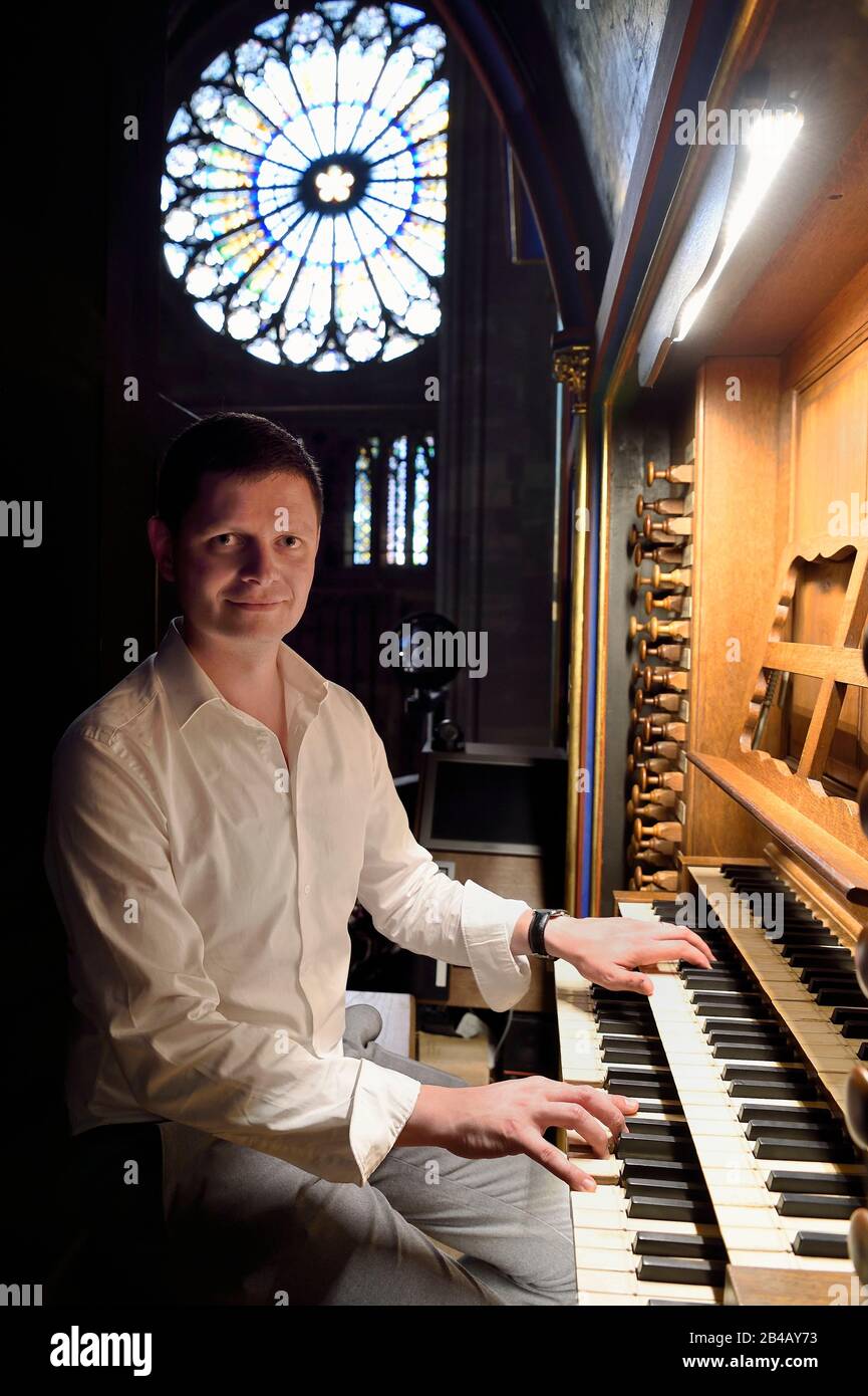 France, Bas Rhin, Strasbourg, old town listed as World Heritage by UNESCO, Notre Dame Cathedral, the organist Guillaume Nussbaum at the the great organ that dominates the nave Stock Photo