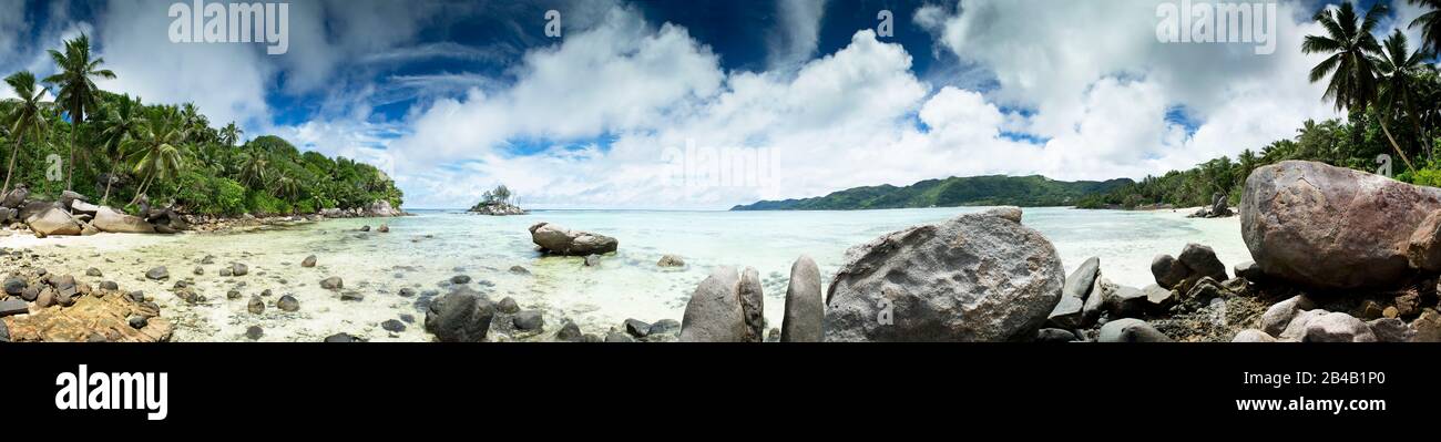 Seychelles, Mahe Island, panoramic view ofwhite sand beach and granite rocks in Anse Royale and Souris Island Stock Photo