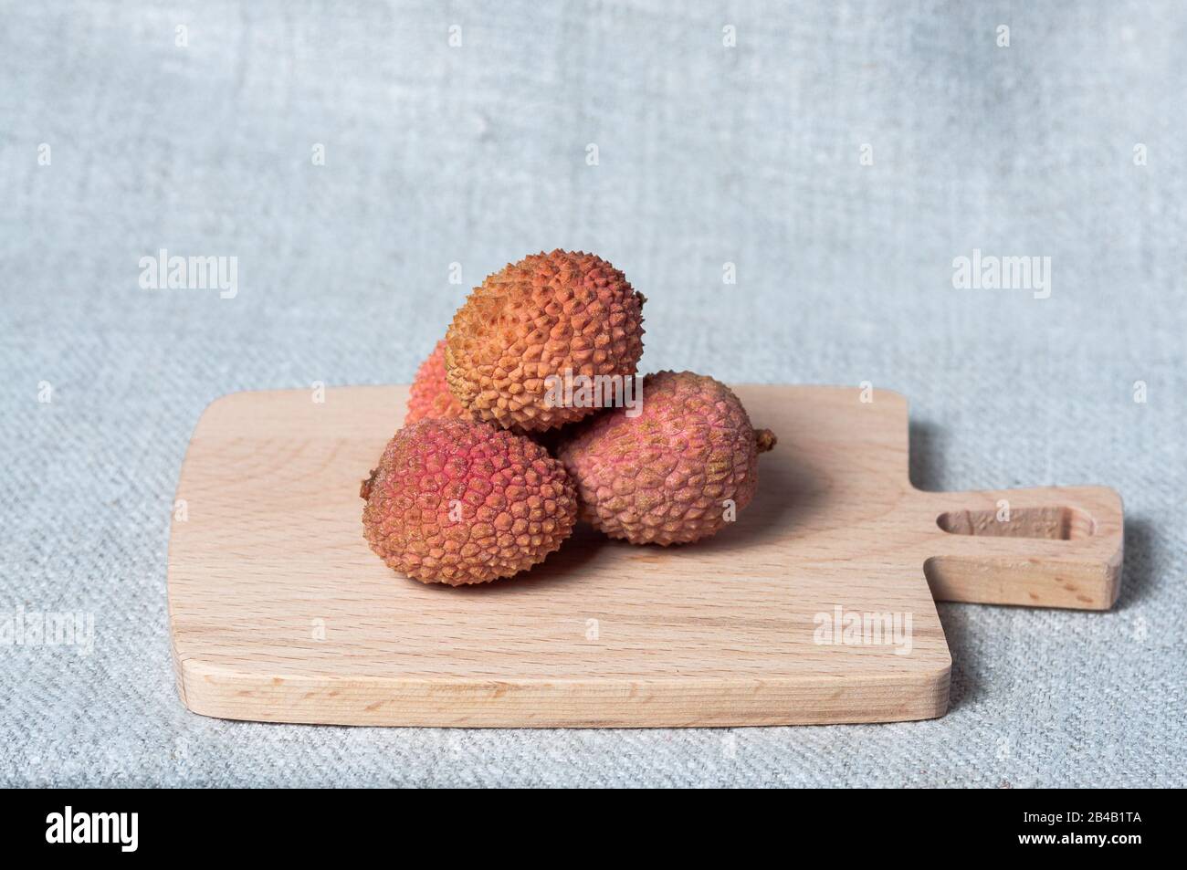 Close-up of fresh fruit lychee on wooden board Stock Photo