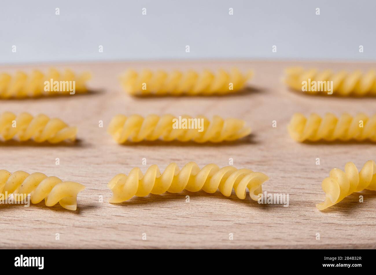 Pasta girandole types in wooden background. Italian noodles close up Stock Photo