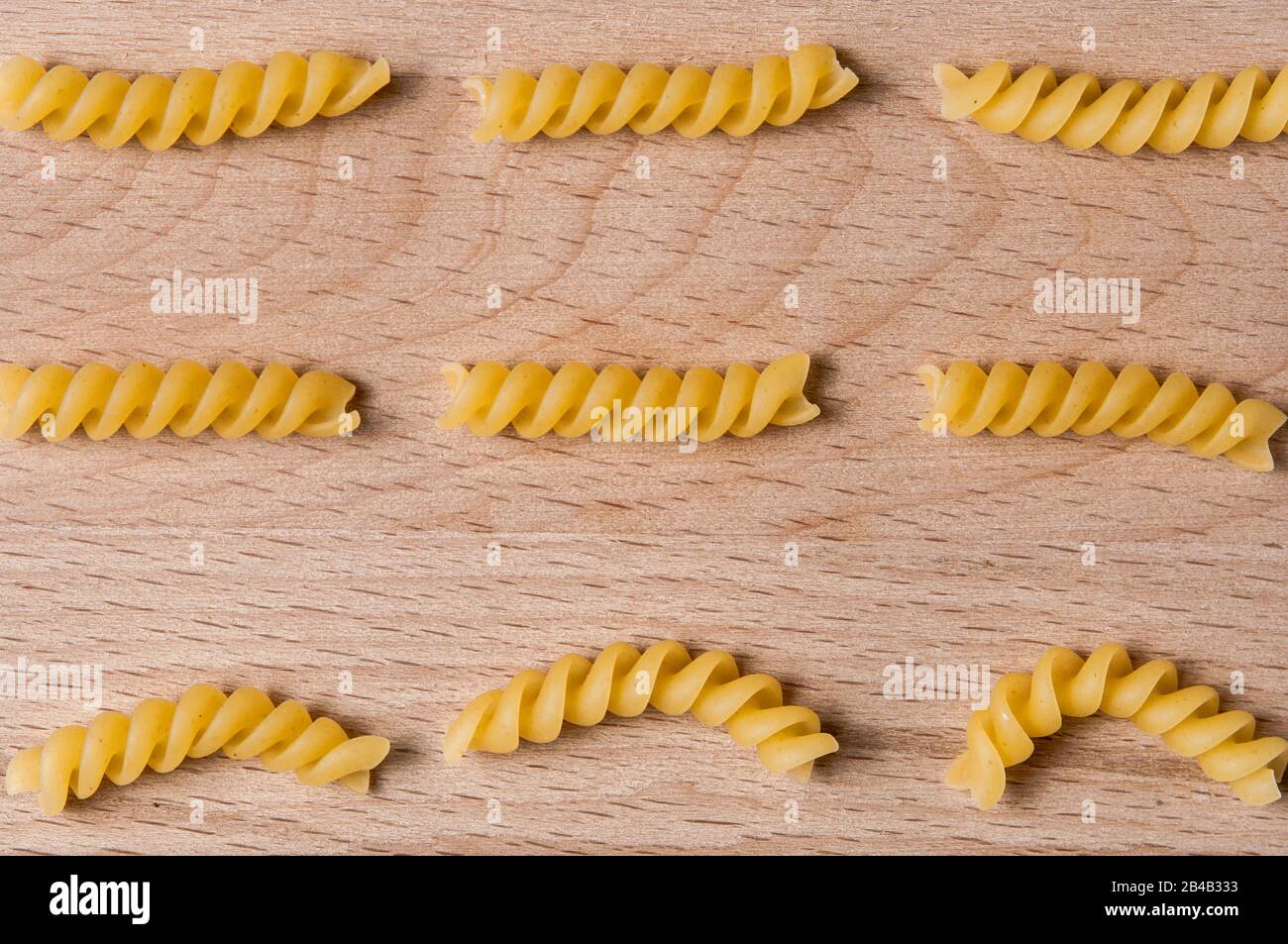 Pasta girandole types in wooden background. Italian noodles close up Stock Photo