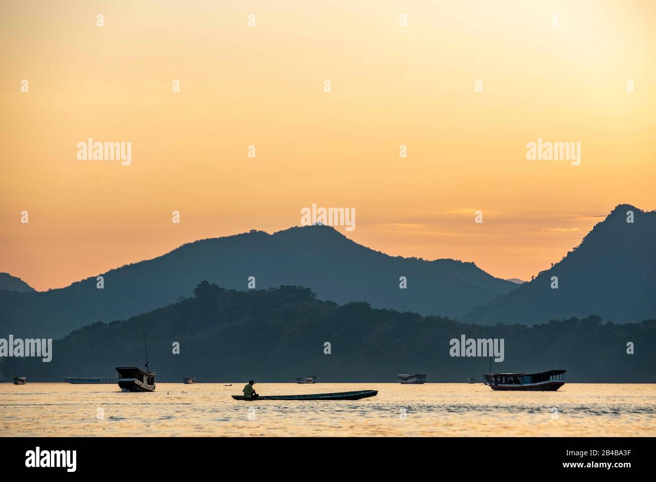 Laos, Luang Prabang, listed as World Heritage by UNESCO, sunset over Mekong River, fisherman Stock Photo