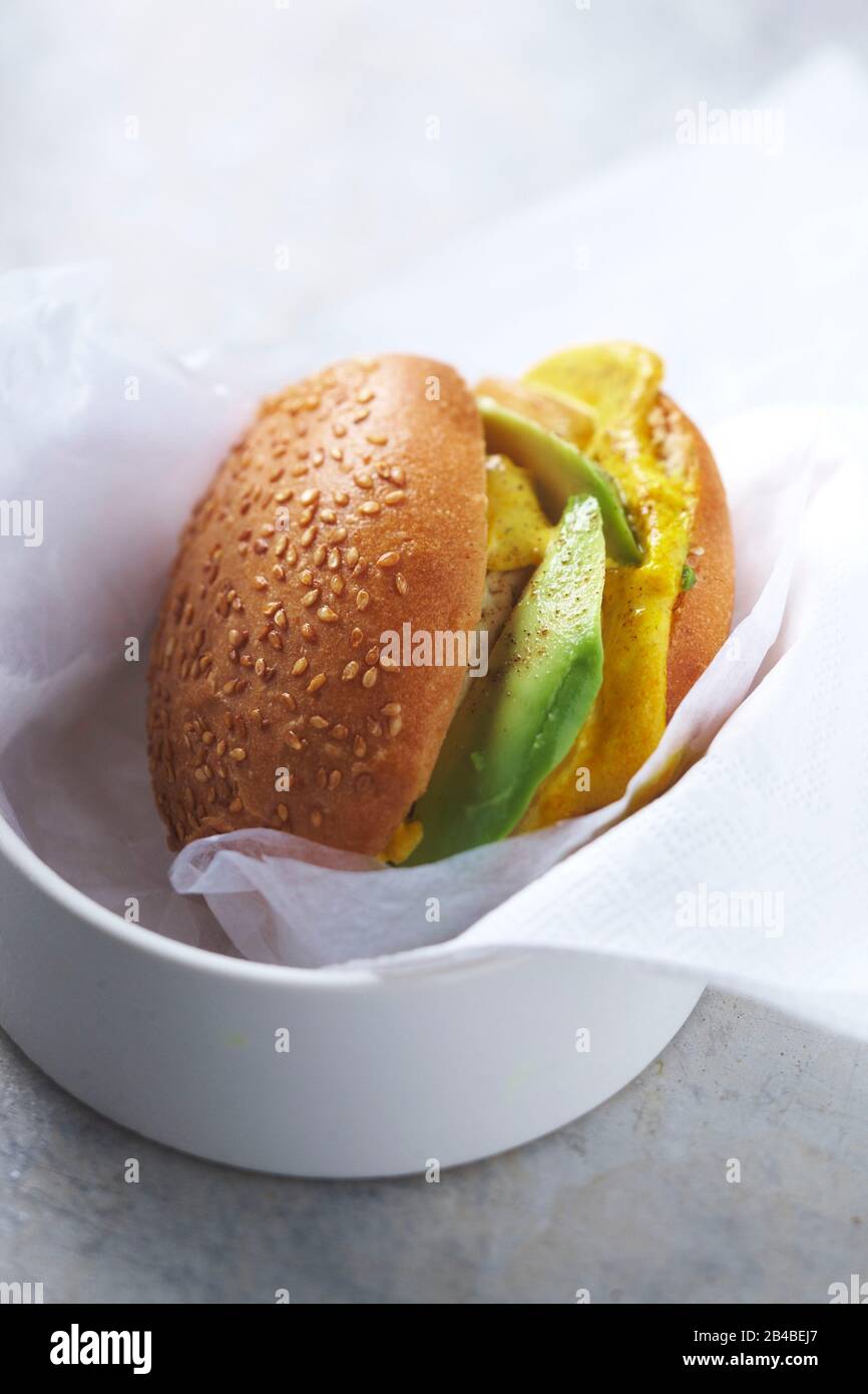 Avocado and pear curry goat burger Stock Photo Alamy