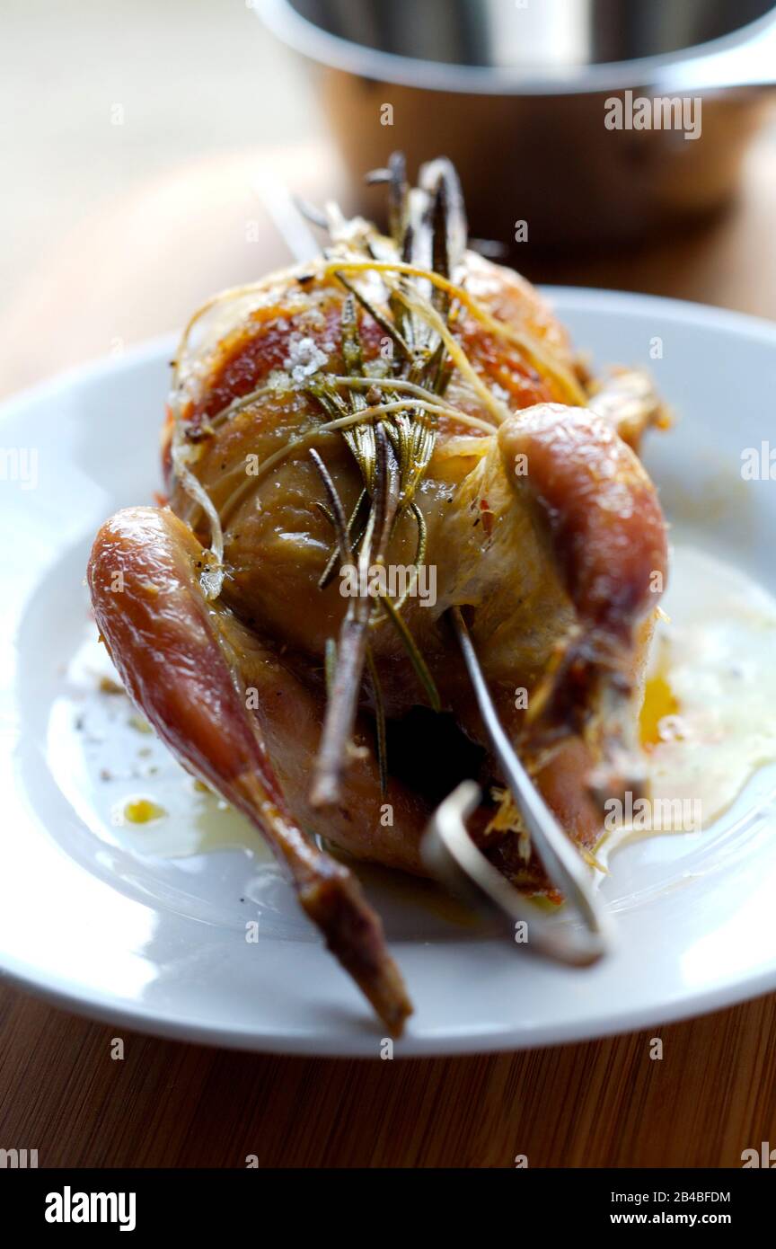 Whole grilled quail with smoked bacon and aromatic herbs Stock Photo