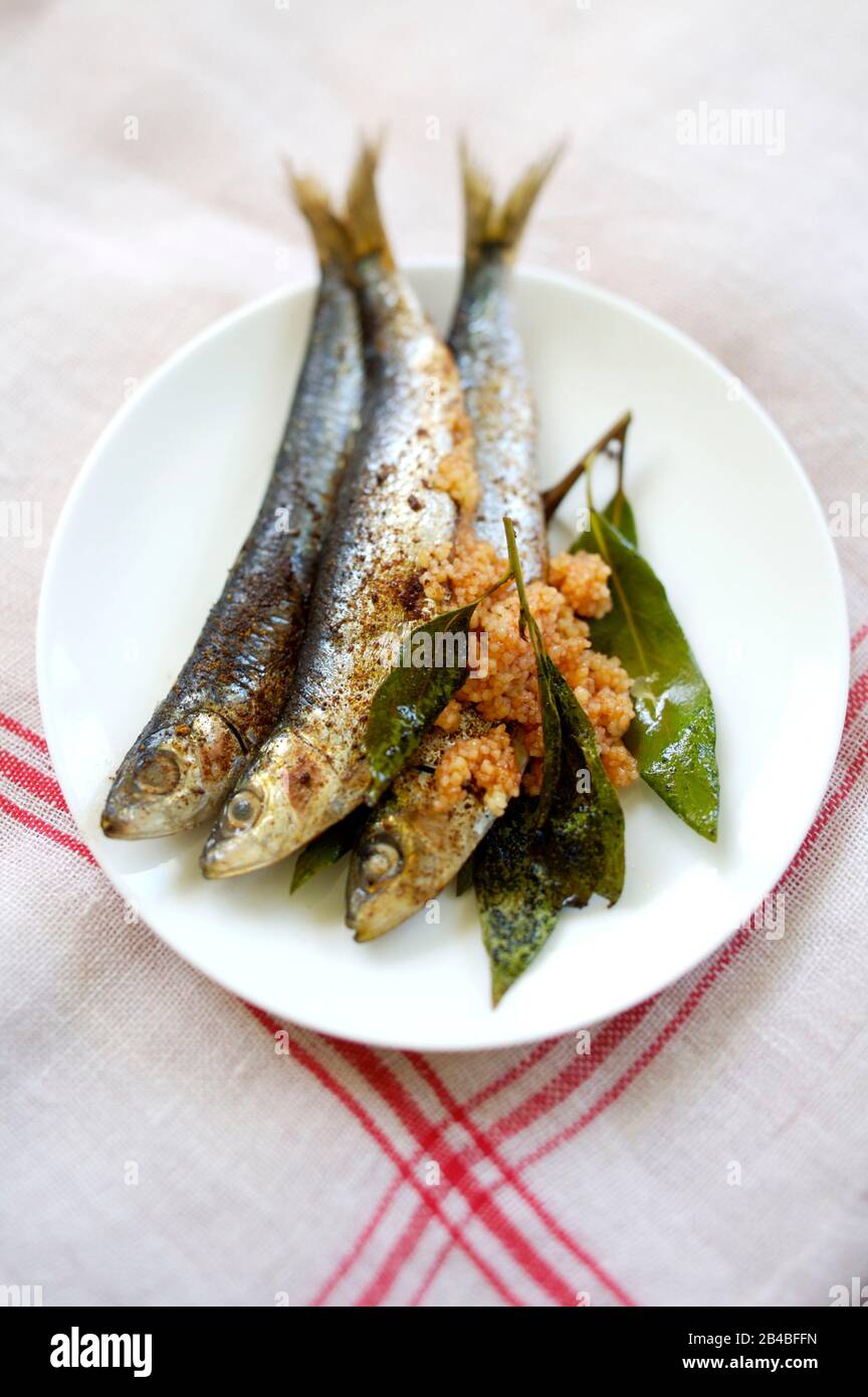 Plancha cooking, sardines with harissa Stock Photo Alamy