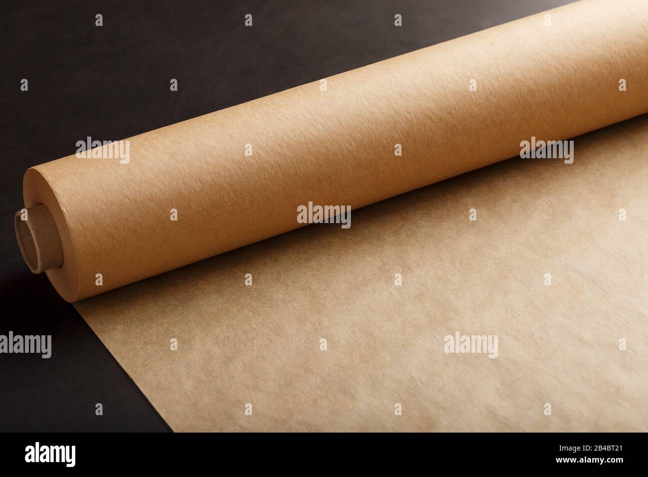 A roll of unfolded brown parchment paper, for baking food in on a