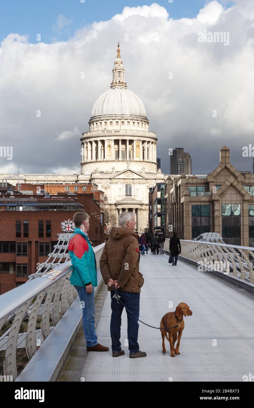 Dog walking London - walking the dog on the Millennium Bridge near St Pauls cathedral, City of london UK - example London Lifestyle Stock Photo