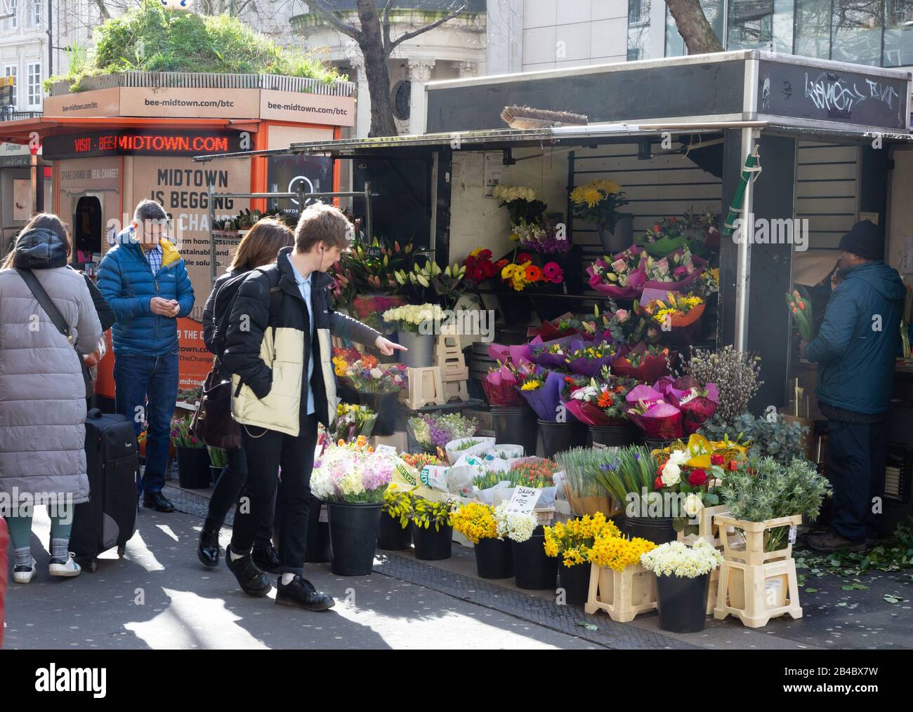 Flower stall London people shopping for flowers at a street flower