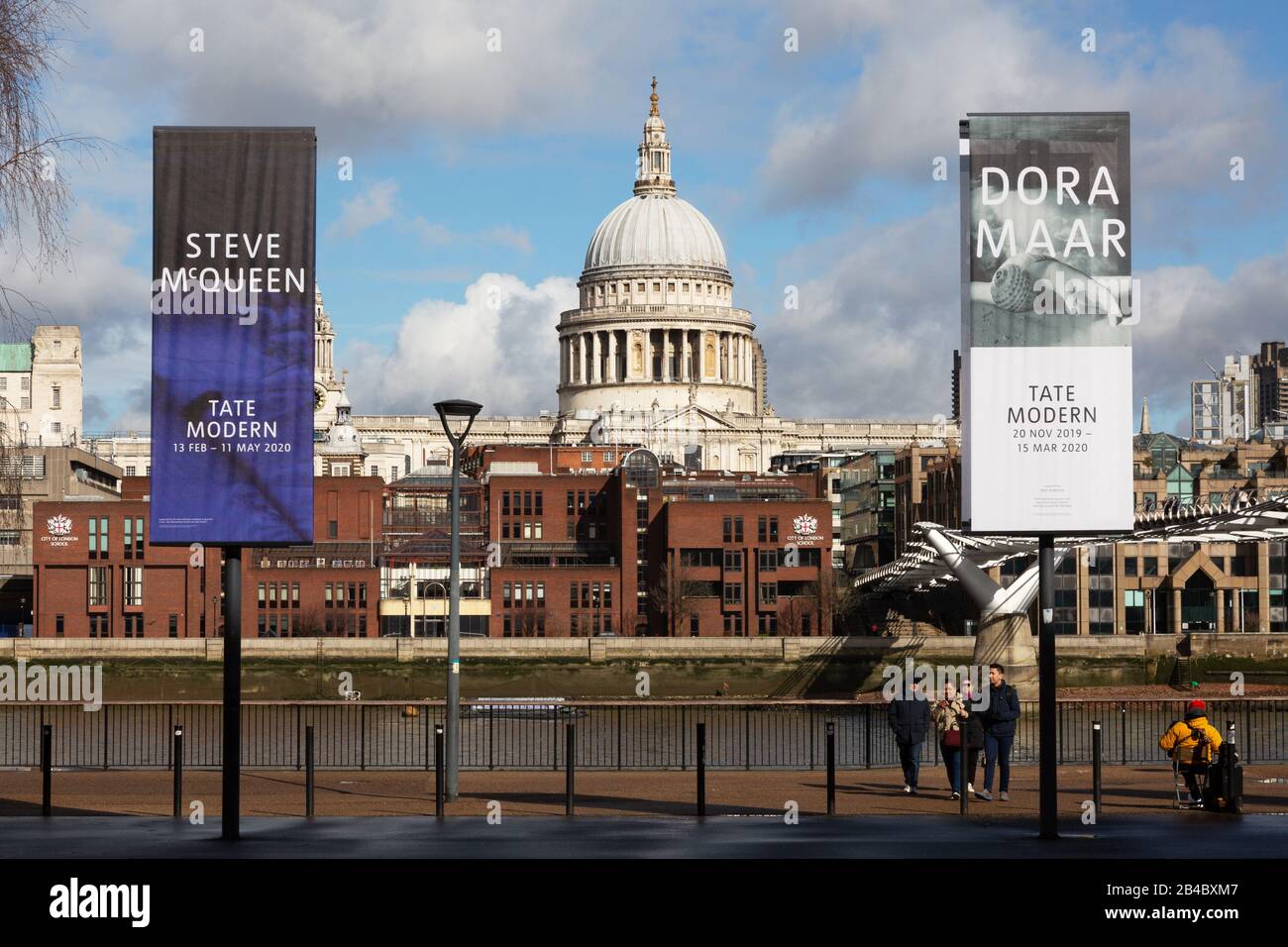 London South Bank - St Pauls Cathedral flanked by signs for the Tate Modern Art Gallery, and the river Thames, South Bank, London UK Stock Photo