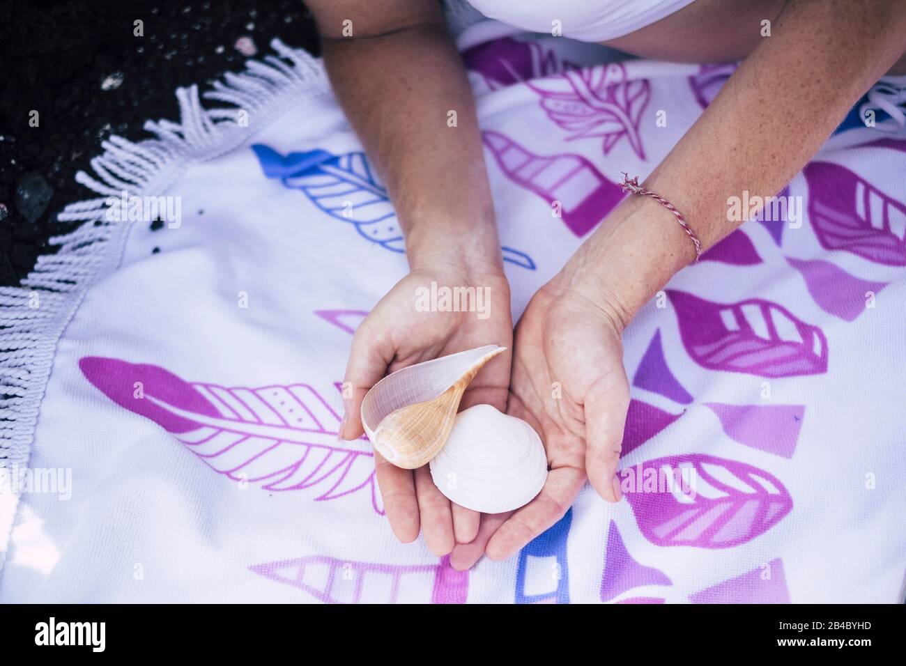 Couple of shell in caucasian girls hands showed at the camera for summer holiday vacation sea concept Stock Photo