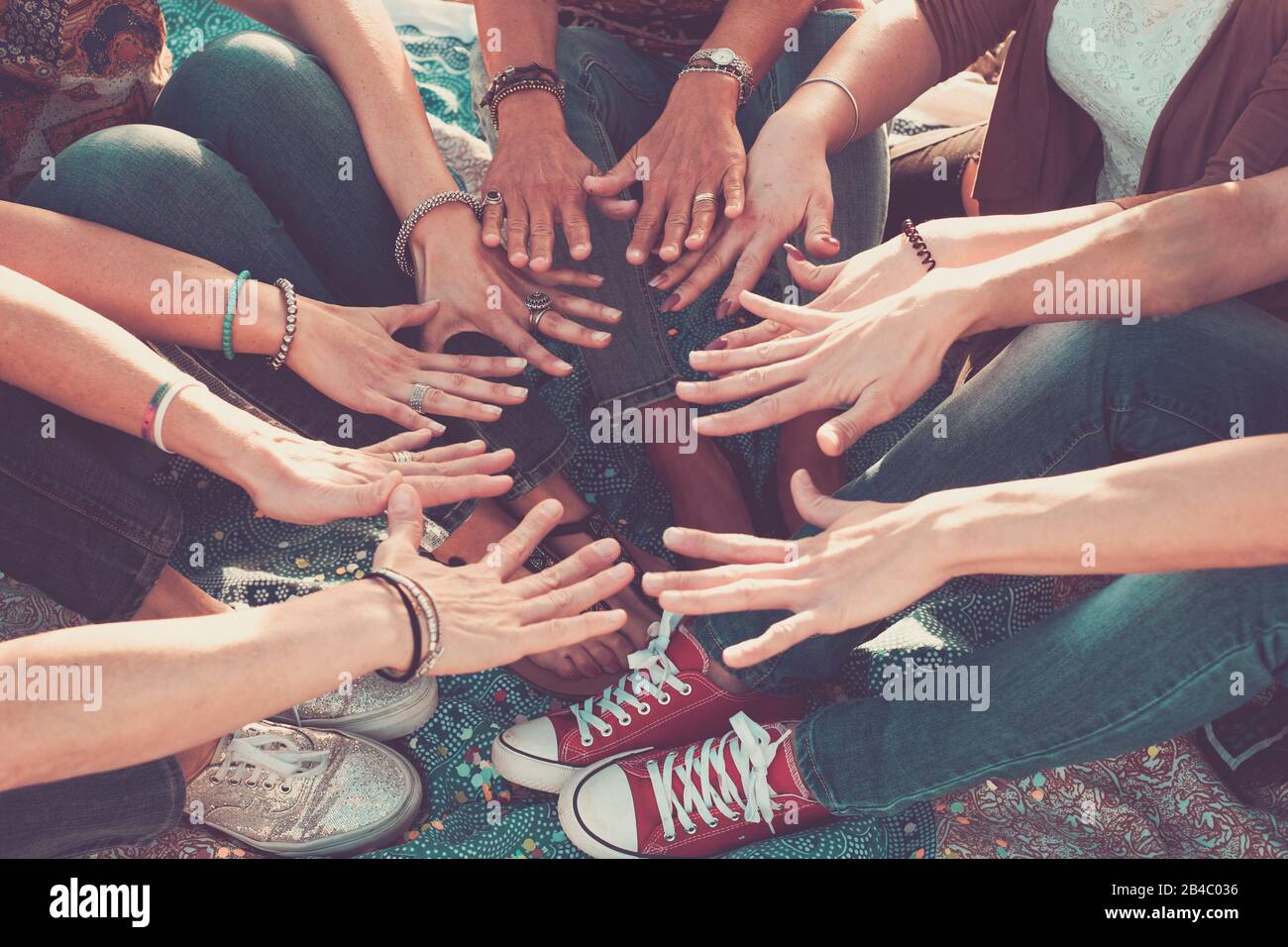 team and friendship concept with crowd of hands and feet all together touching and cooperate - caucasian people friends enjoying the outdoor leisure activity - hippy love Stock Photo