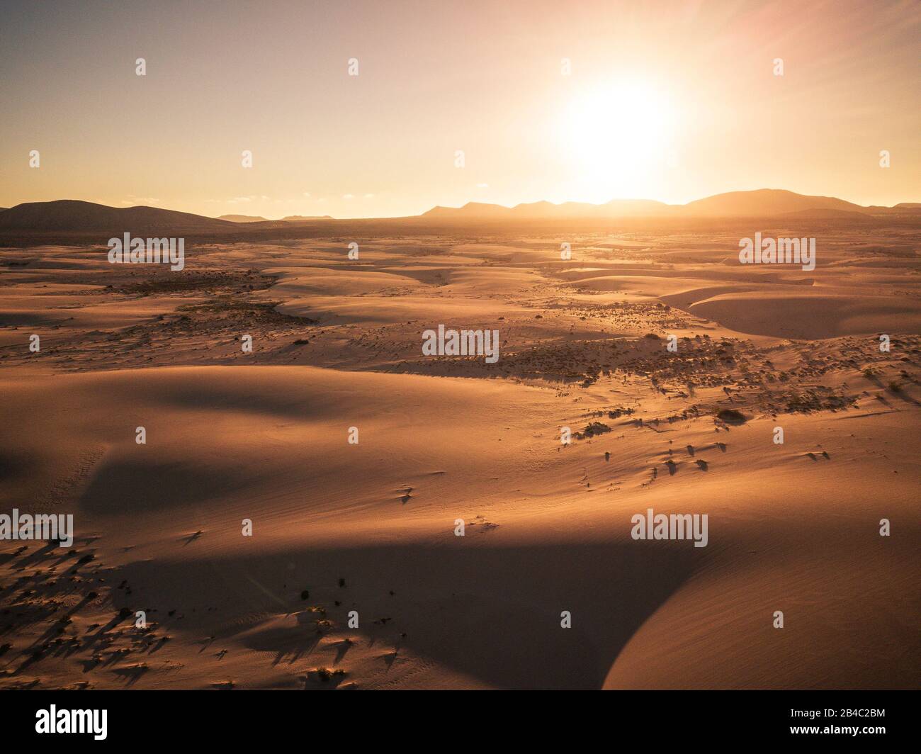 Beautiful desert and dunes view from above with sun and shadows on the sand - amazing nature outdoors and concept of beauty of the world and wild places to visit and enjoy - Stock Photo
