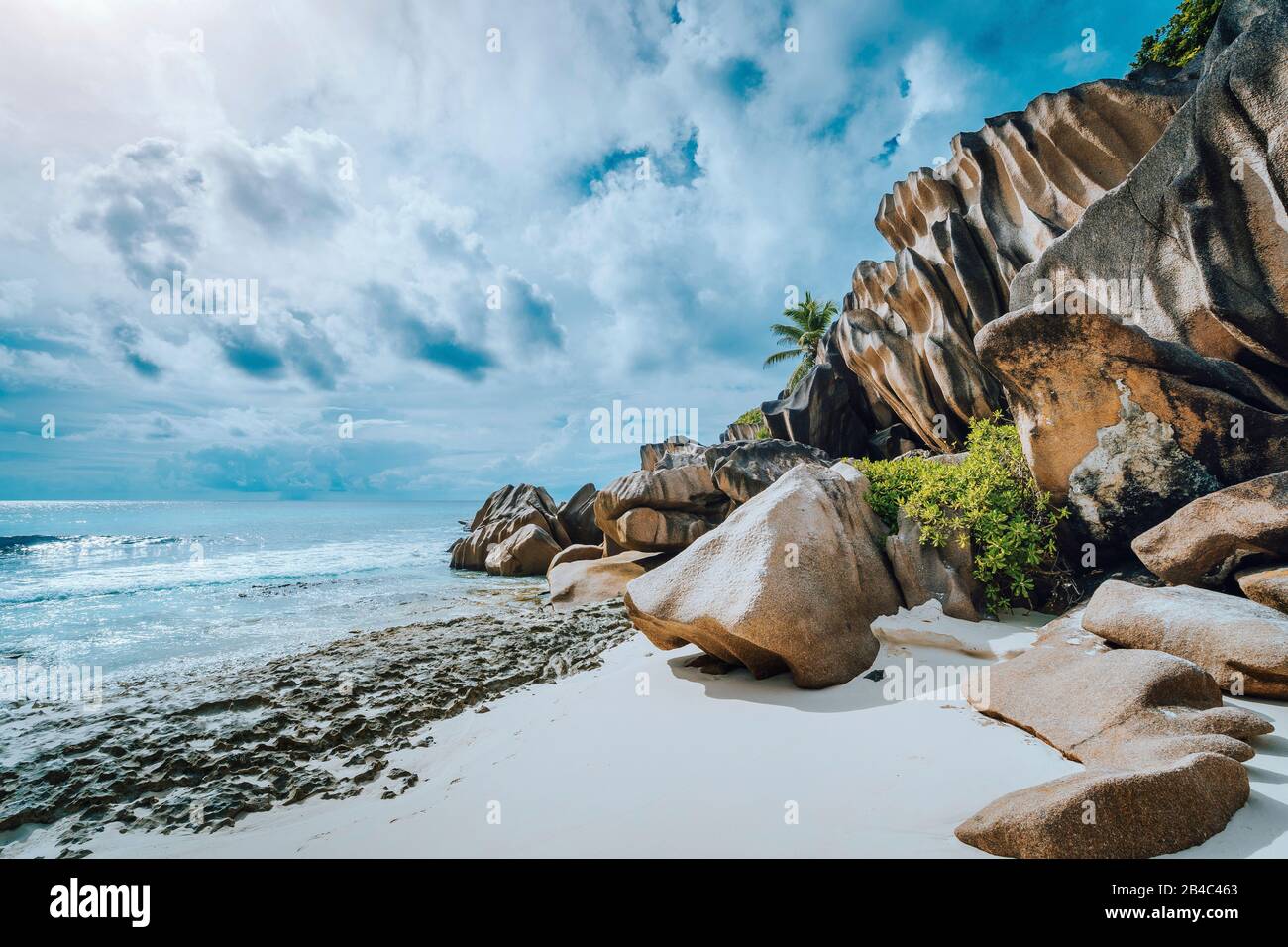 Picturesque granite boulders formation on tropical white sand beach Grand Anse, La Digue island, Seychelles. Stock Photo