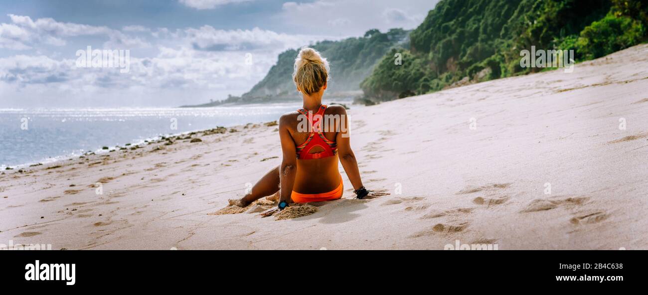 Tanned blonde tourist woman on summer vacation, beach, Bali. Travel wanderlust vacation concept. Stock Photo