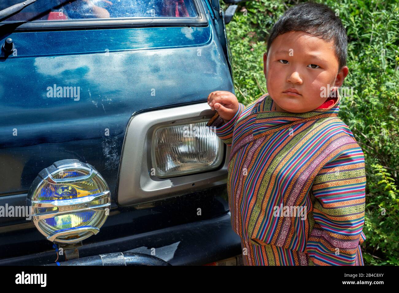 Portrait of cute little boy with traditional clothign in a festival in Ugyen Pema Woedling Zangthopelri temple Paro Bhutan Stock Photo