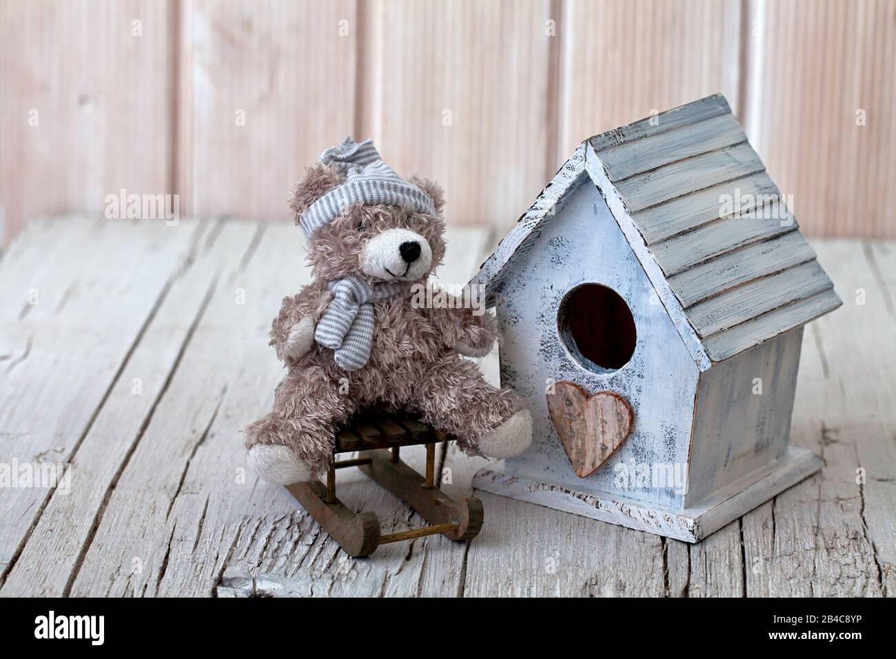 Cute little wooden house with teddy bear on a sledge hi-res stock ...