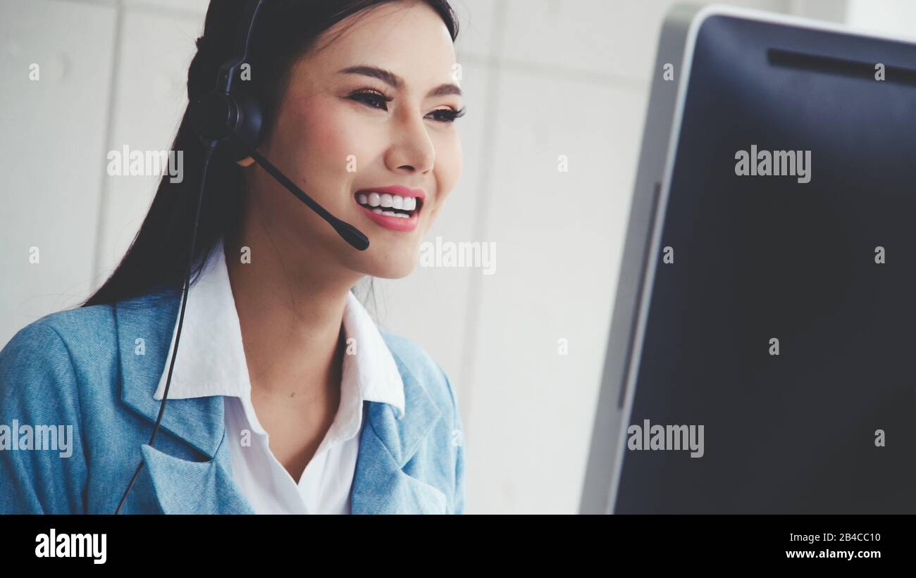 Customer support agent or call center with headset works on desktop