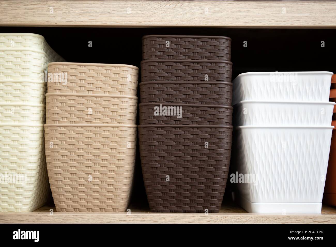 Shelf with plastic flower pots. Stock for flowers Stock Photo