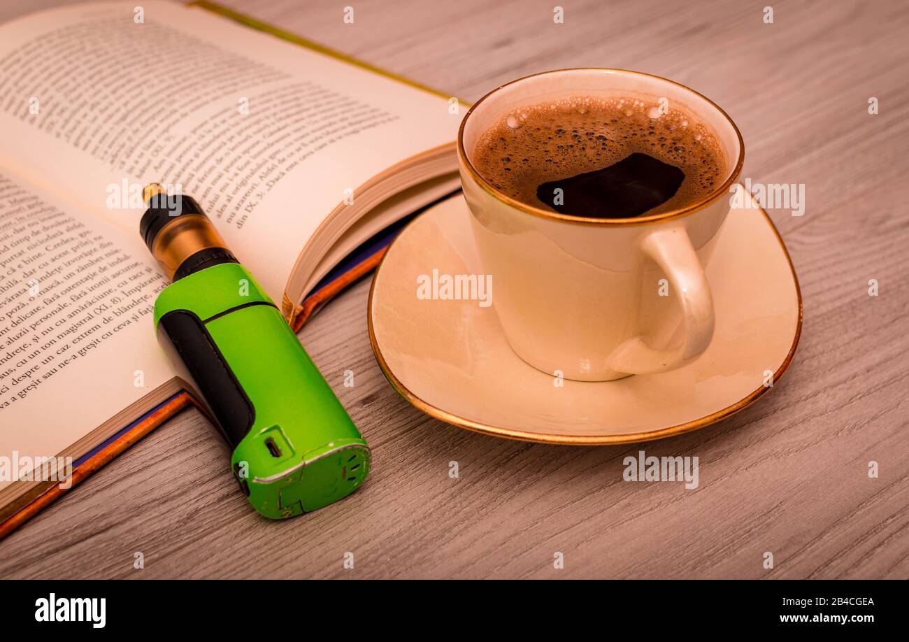 Vape next to a cup of coffee Stock Photo Alamy
