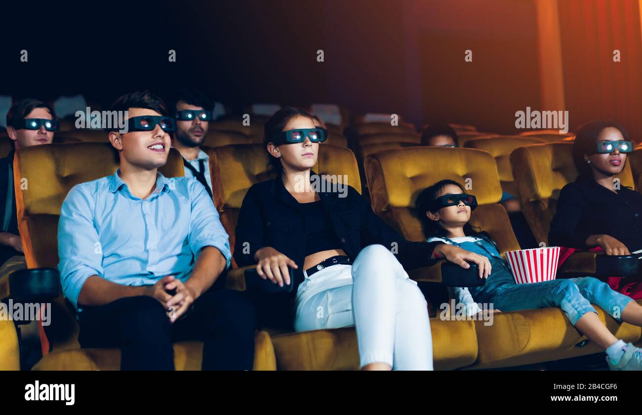 Group of people watch movie with 3D glasses in cinema theater with