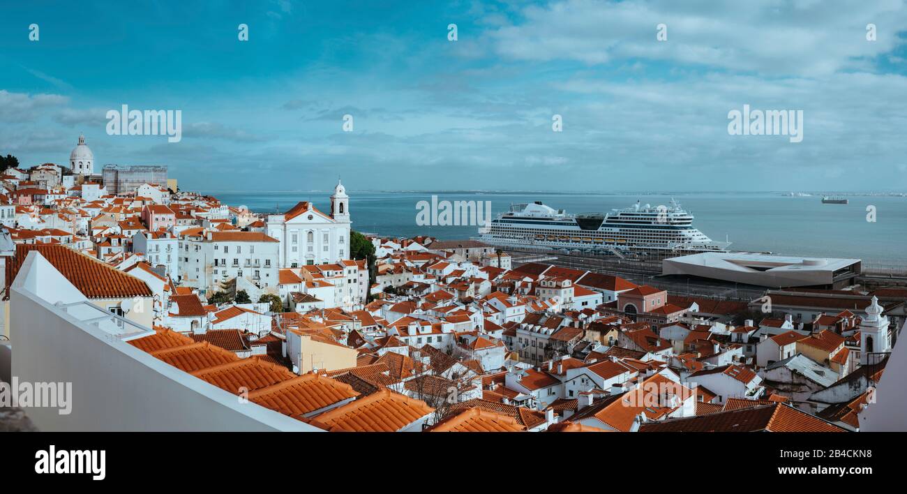 Panoramic shot of Rooftops in the oldest district Alfama in Lisbon. Cruise boat on the Tagus River. Lisbon, Lisboa, Lissabon, Portugal, Europe Stock Photo