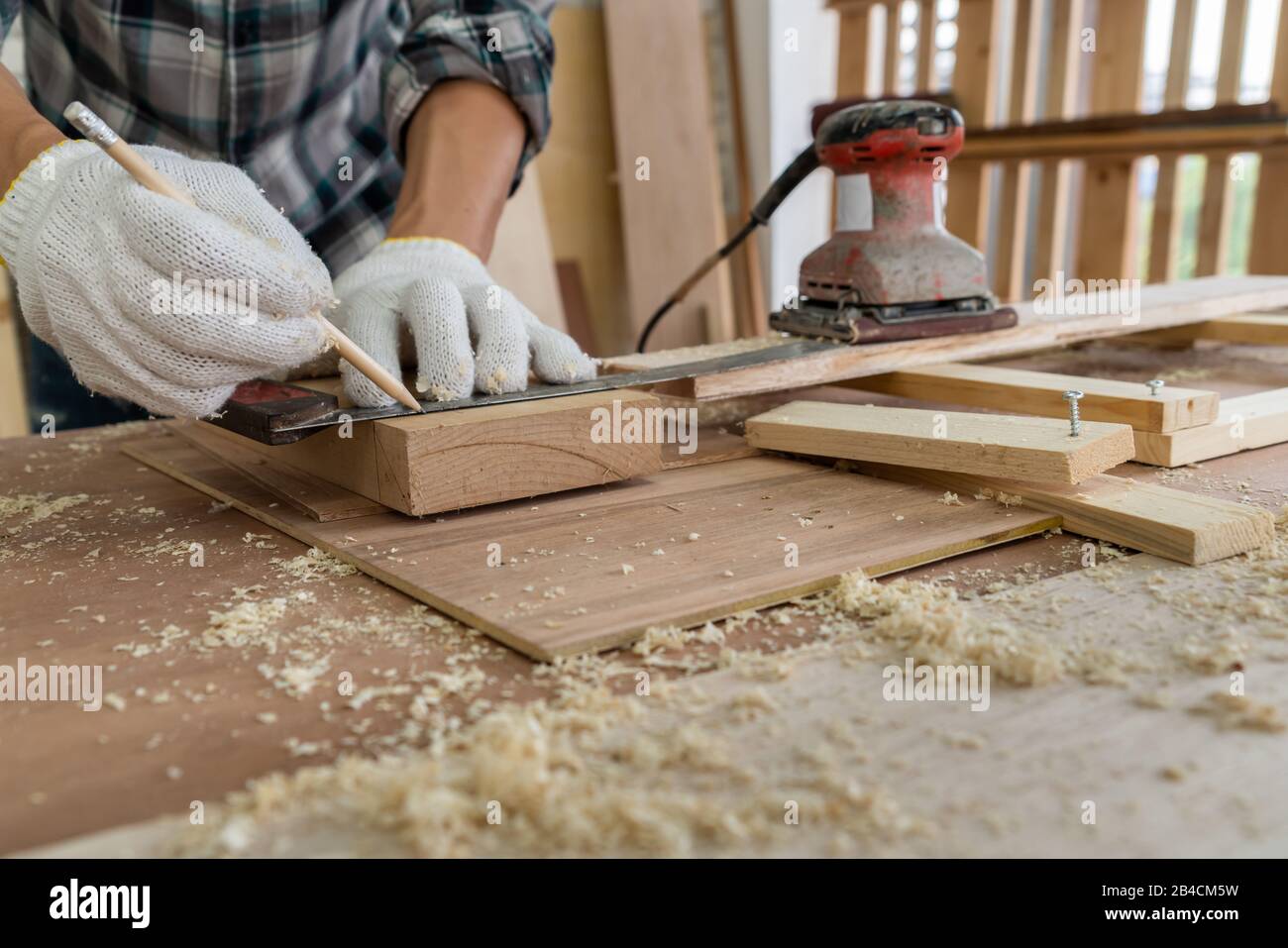 Carpenter working on wood craft at to produce construction