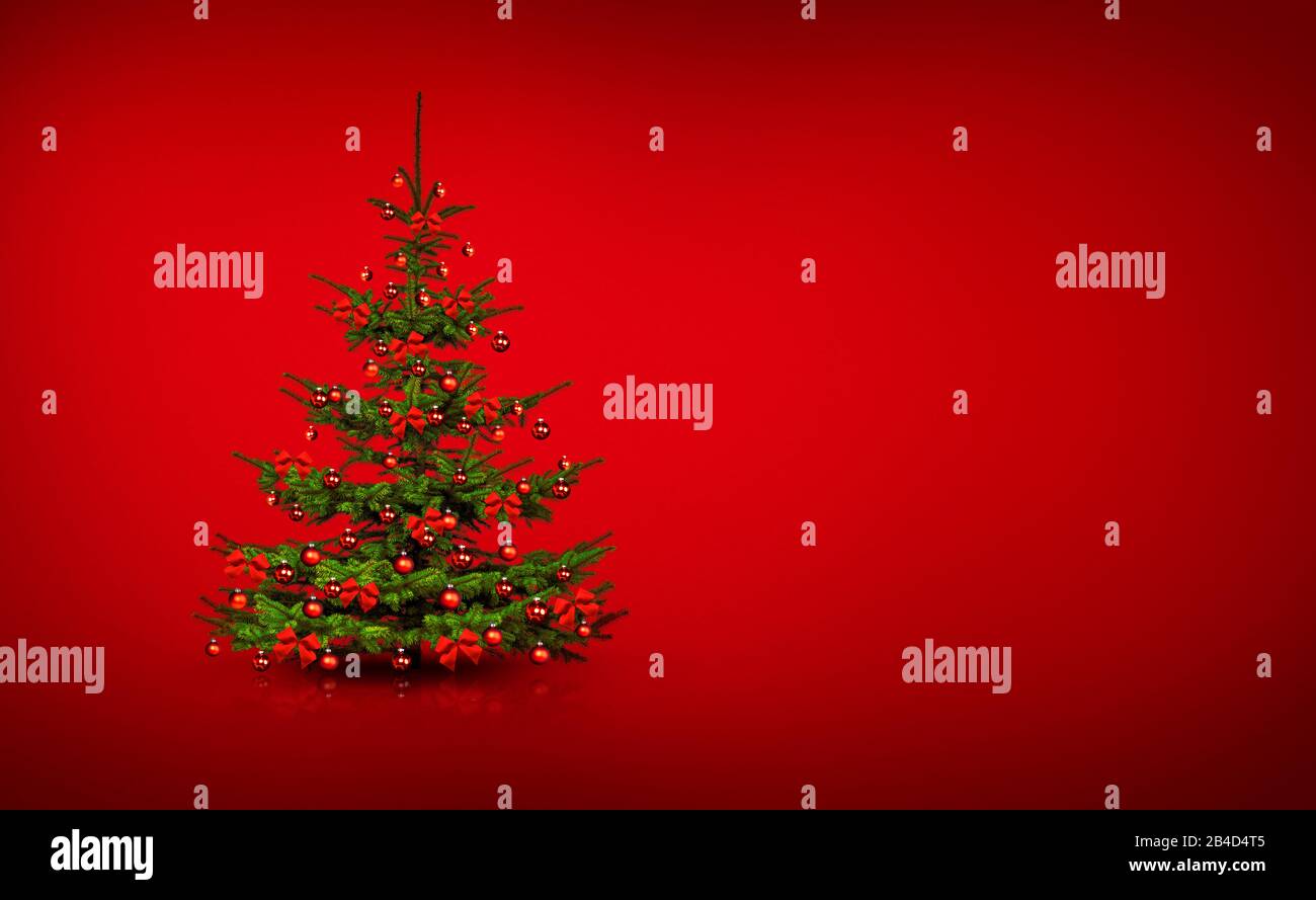 Beautifully decorated Christmas tree with red bows and red Christmas balls on a red background Stock Photo