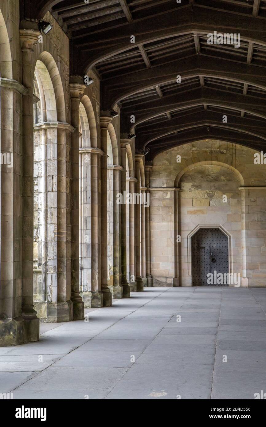 historic archway with stone columns and wooden ceilling in ST. andrews Stock Photo