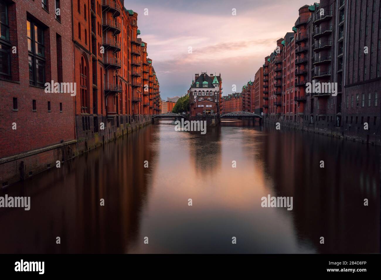 Hamburg, Warehouse District Speicherstadt, Germany, Europe, View of Wandrahmsfleet on evening light, famous sightsee located in the port of Hamburg, Stock Photo