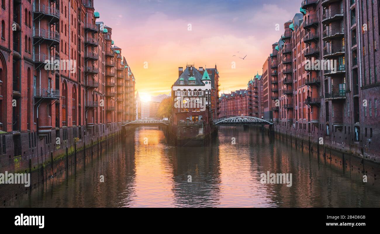 Old port of Hamburg, Germany, Europe, historic warehouse district with moated palace in the golden light of sunset Stock Photo