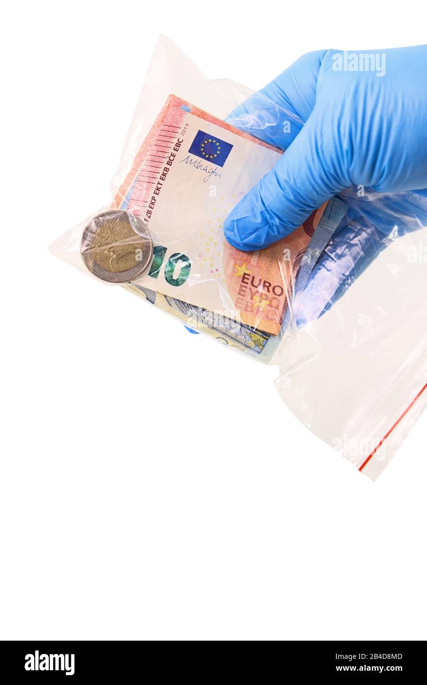 A hand in a medical glove holds a transparent plastic bag with money that is a source of infection. Isolated on white background Stock Photo