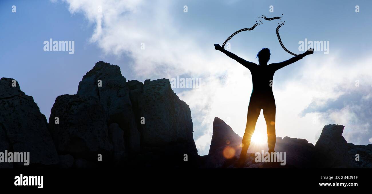 Silhoutte of a woman with broken chains Stock Photo