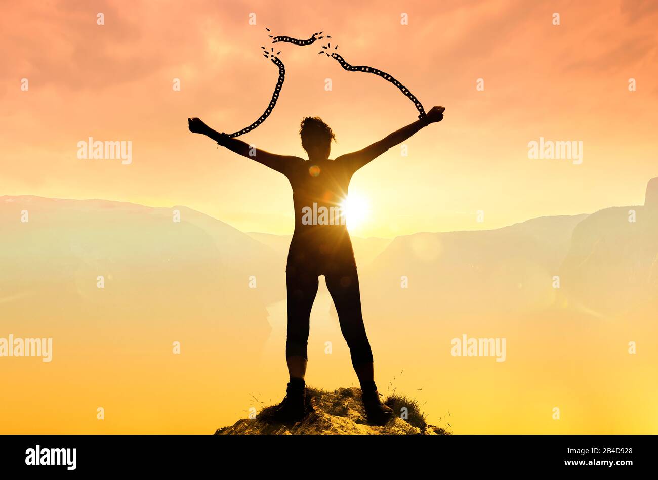 Silhoutte of a woman with broken chains Stock Photo