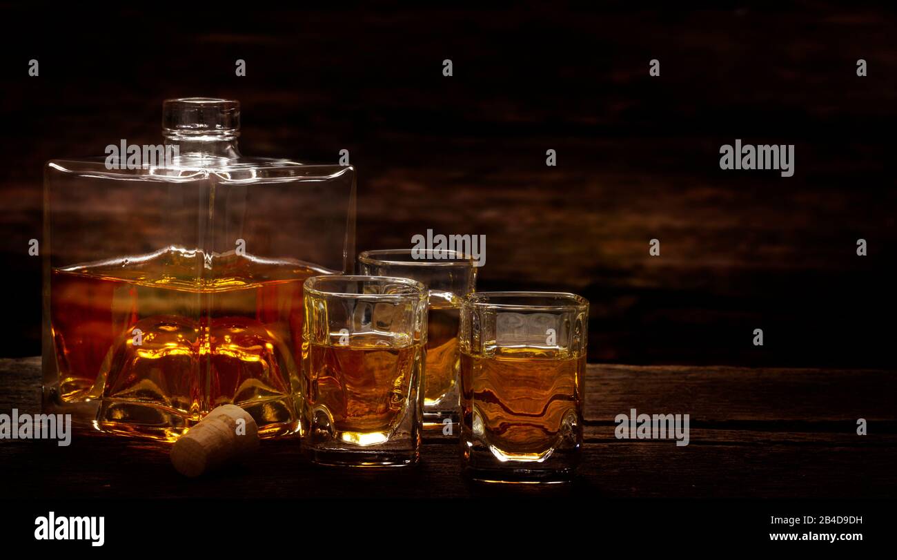 Poured whiskey from the bottle into whiskey glasses in a bar Stock Photo